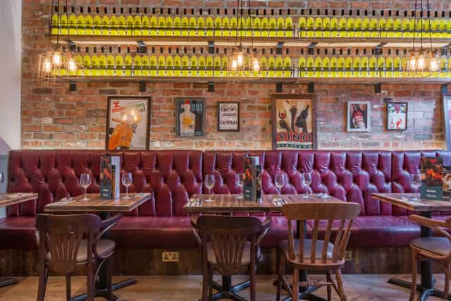 Stylish Venice Room restaurant with burgundy seating, perfect for dining events.