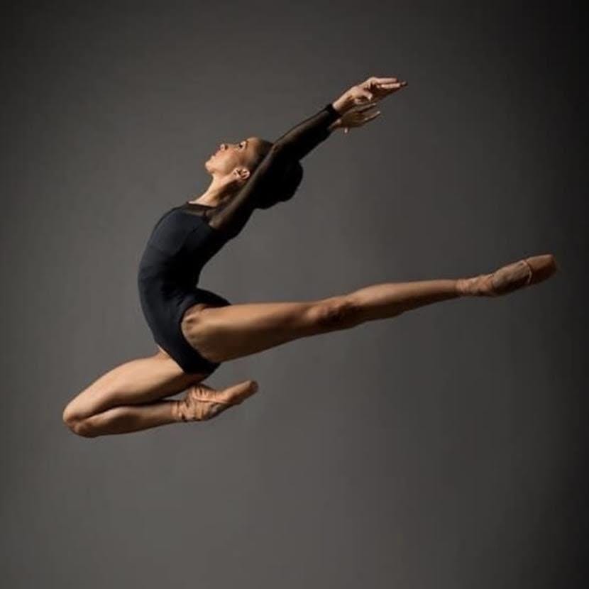 Dancer mid-leap in recording studio, symbolizing dynamic event performances and creativity.