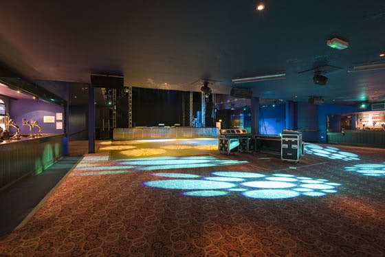 Versatile event space at O2 Academy Leeds with ambient lighting for corporate and social gatherings.