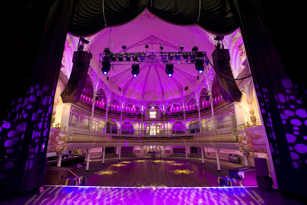 Elegant event space at O2 Academy Bournemouth with high ceiling and vibrant lighting.