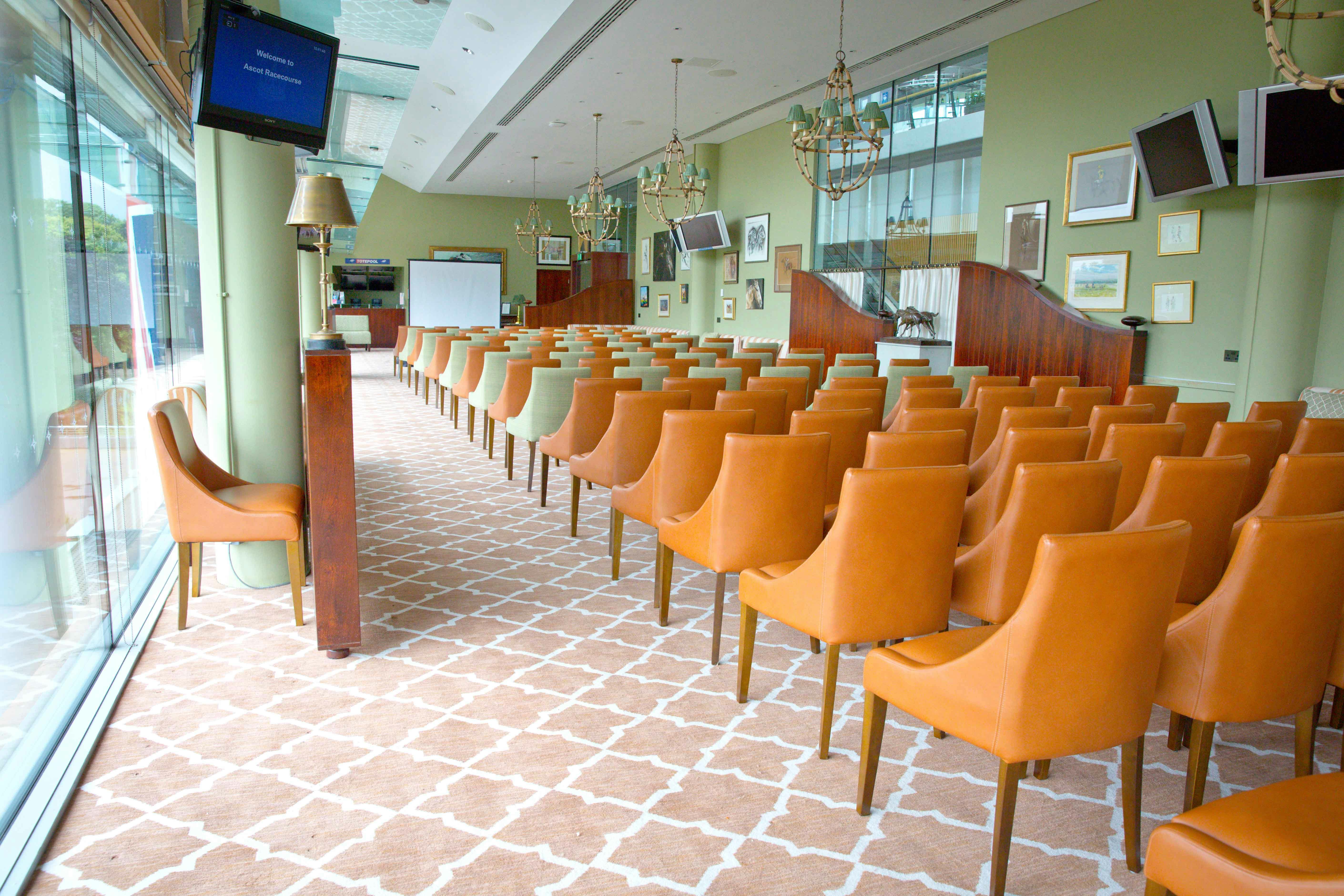 Royal Ascot Racing Club meeting space with orange chairs for events and presentations.