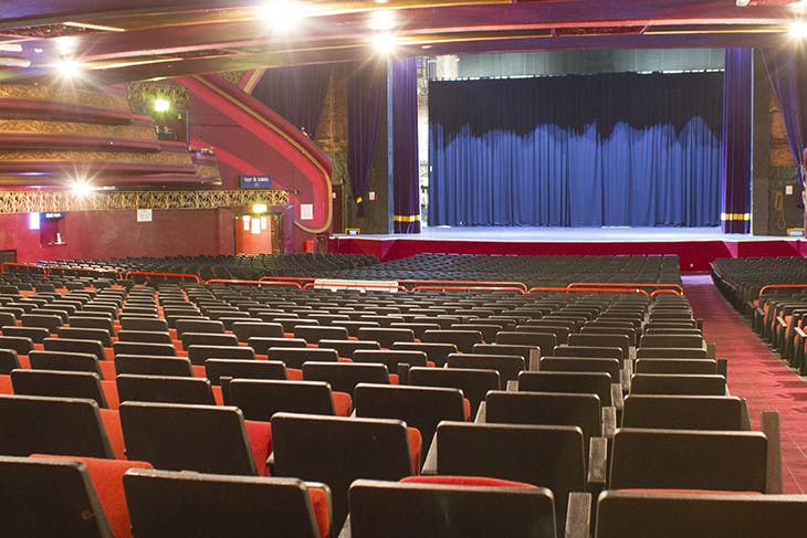 O2 Apollo Manchester auditorium with blue curtains, ideal for conferences and performances.