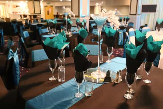 Elegant event space in Viva Blackpool with black and turquoise table settings for celebrations.