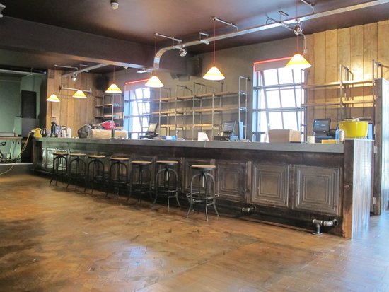 Spacious industrial bar at Arts Club Liverpool, perfect for networking events and gatherings. - Banner
