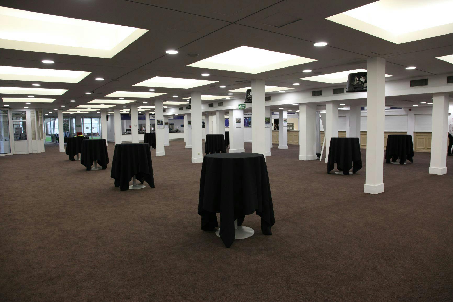 Spacious Ascot Racecourse Exhibition Hall with cocktail tables for networking events.