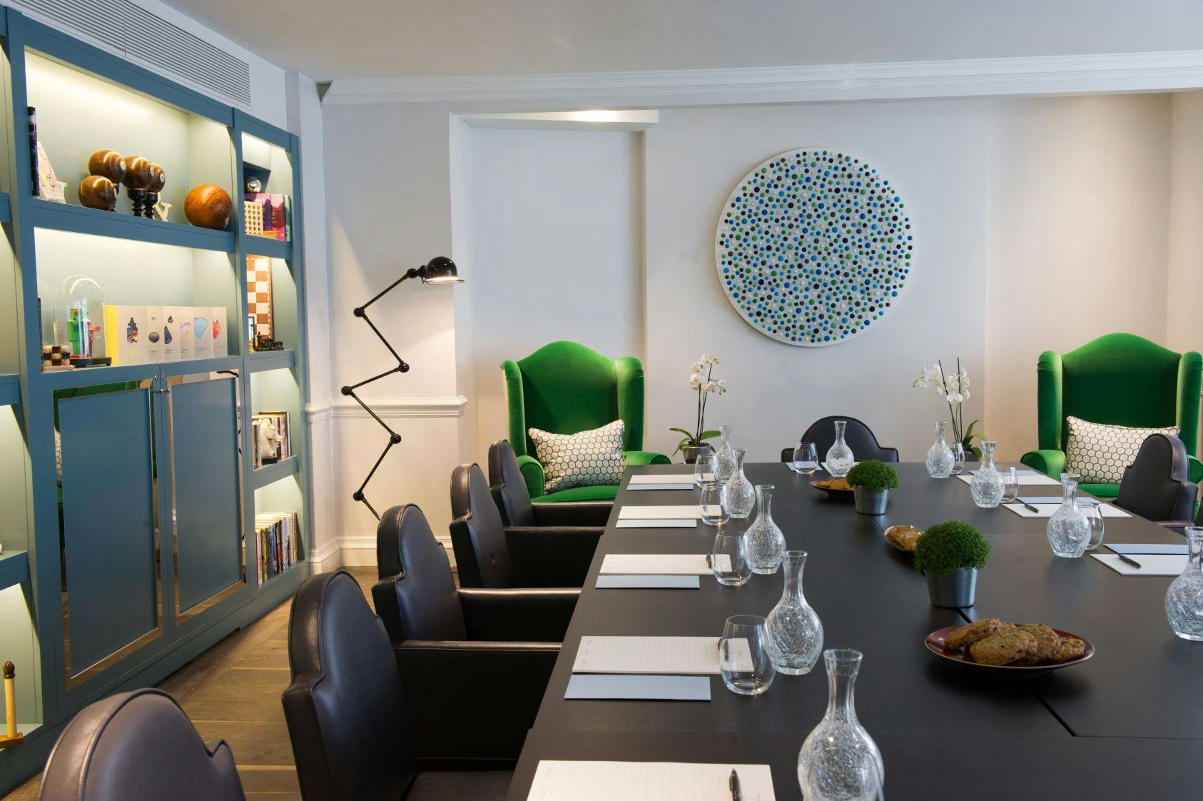 Stylish meeting room at The Ampersand Hotel with vibrant green chairs for events.