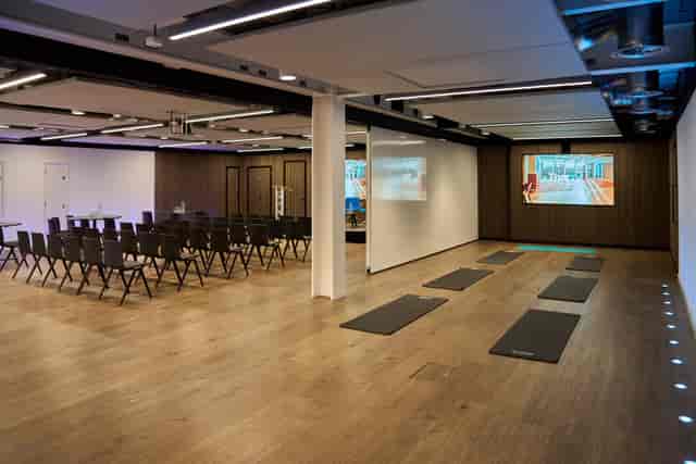 Waterline event space with theater seating and wellness zone for corporate meetings and retreats.
