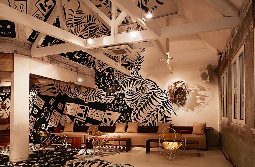 Loft Lounge in Shoreditch: modern meeting space with artistic murals for events.