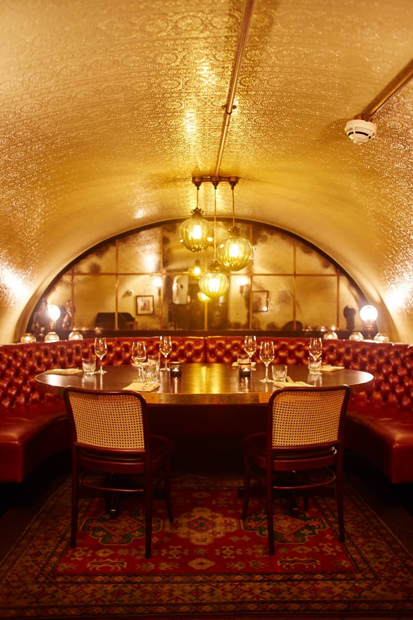 Elegant private dining room with plush red seating, ideal for exclusive events and corporate meetings.