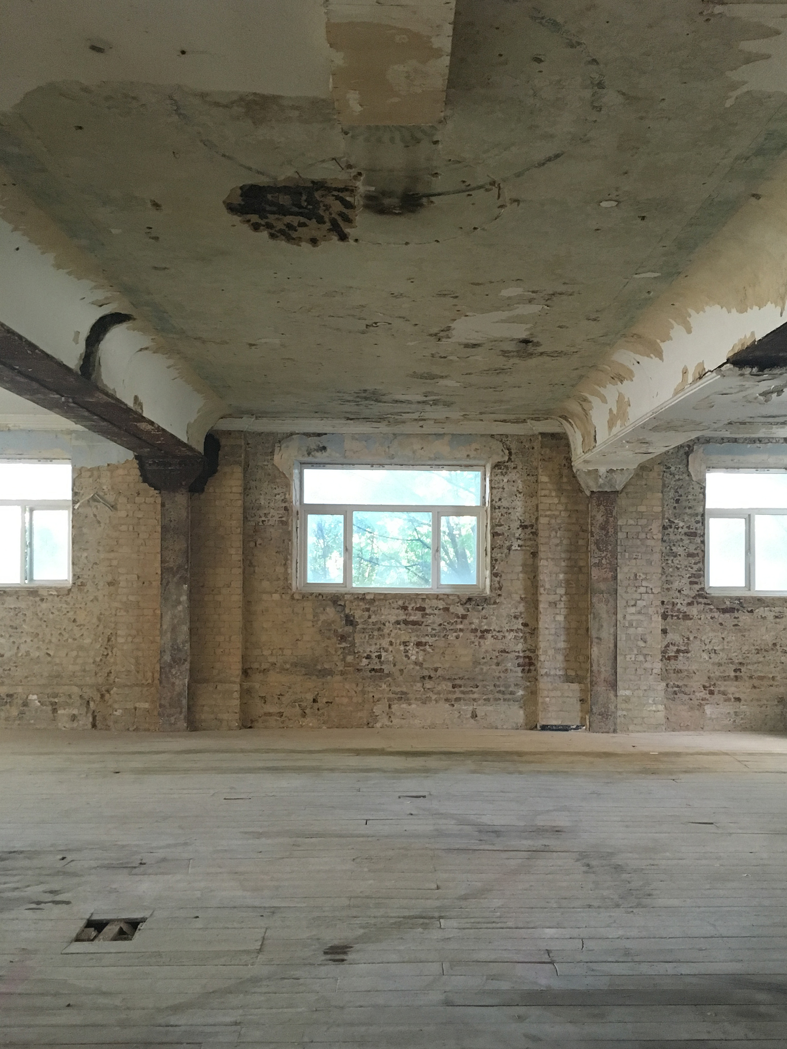 Industrial event space with exposed brick and natural light at 133 Rye Lane.