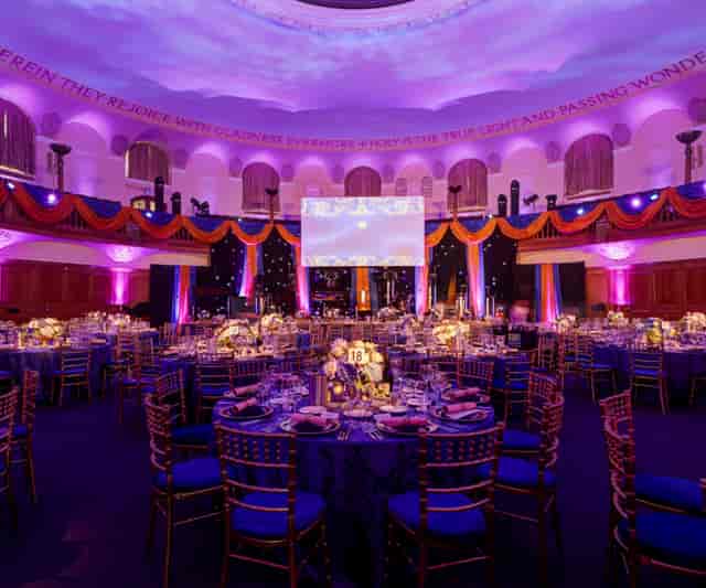 Assembly Hall gala banquet with vibrant uplighting for corporate event venue hire.