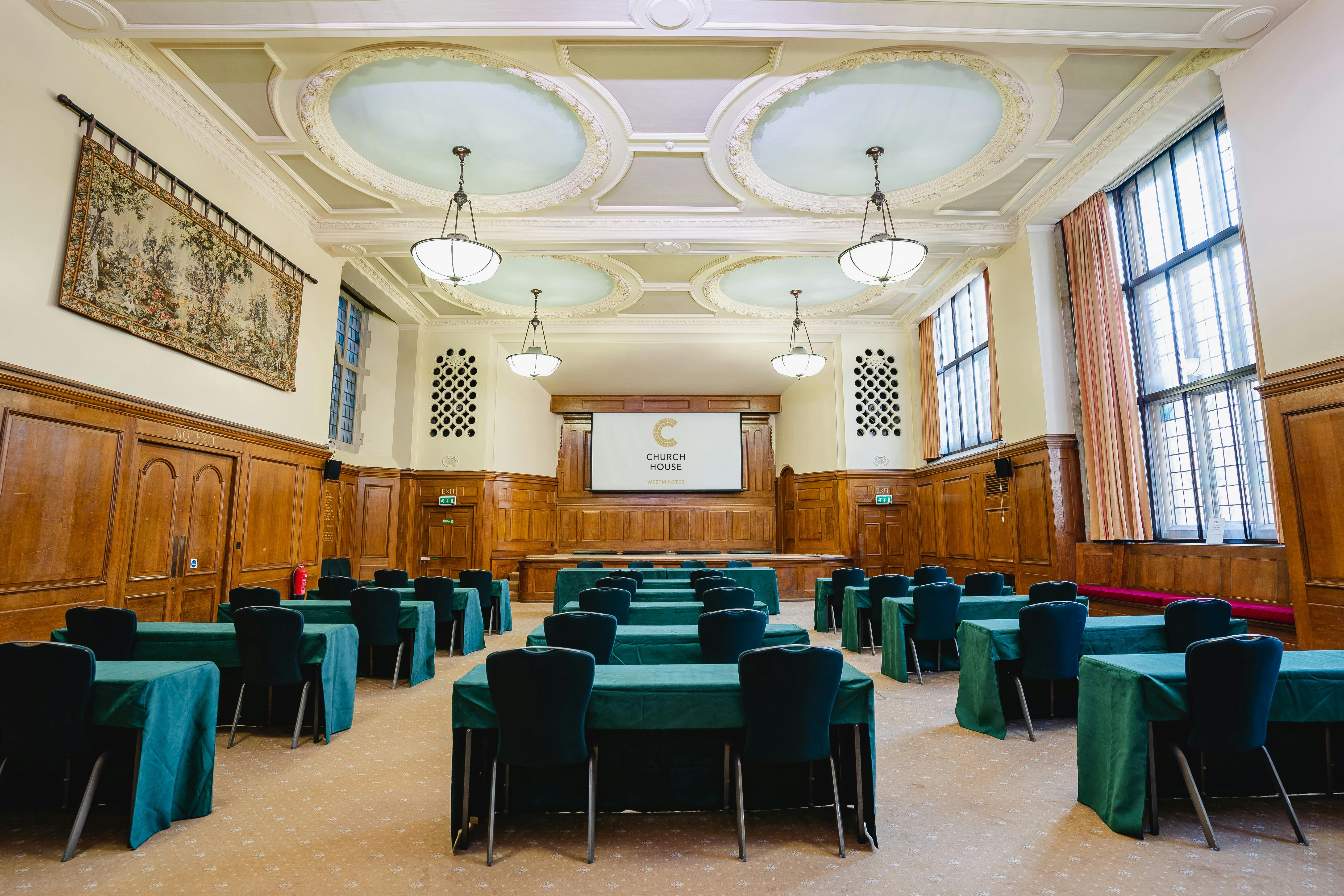 Hoare Memorial Hall: elegant meeting room with wooden paneling for corporate events.