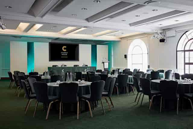 Harvey Goodwin Suite conference room with round tables, ideal for corporate events.
