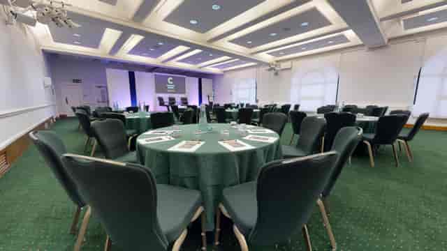 Harvey Goodwin Suite conference room, round tables, stage