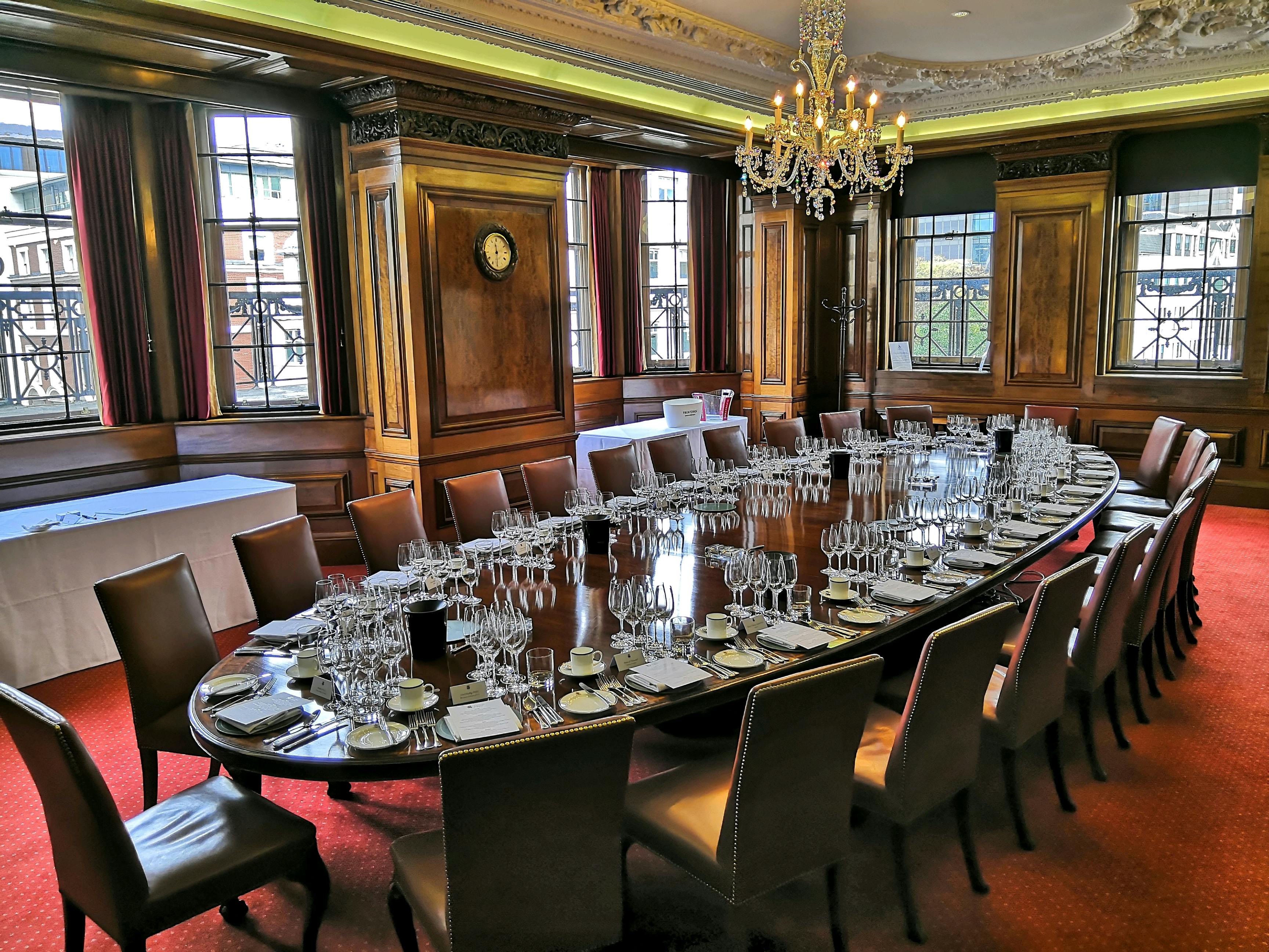 Elegant boardroom in Vintners' Hall with oval table, ideal for meetings and events.