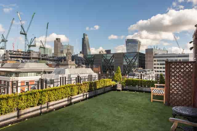 Boardroom at Vintners' Hall: rooftop venue with greenery, perfect for upscale events.