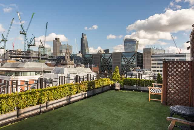 Boardroom at Vintners' Hall: rooftop venue with greenery, perfect for upscale events.