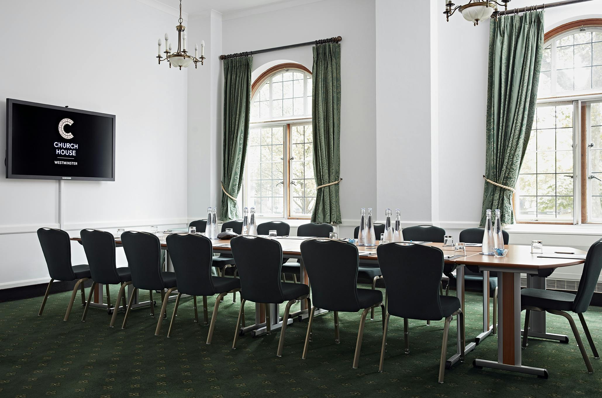 Westminster Room in Church House: elegant meeting space with wooden table, ideal for corporate events.