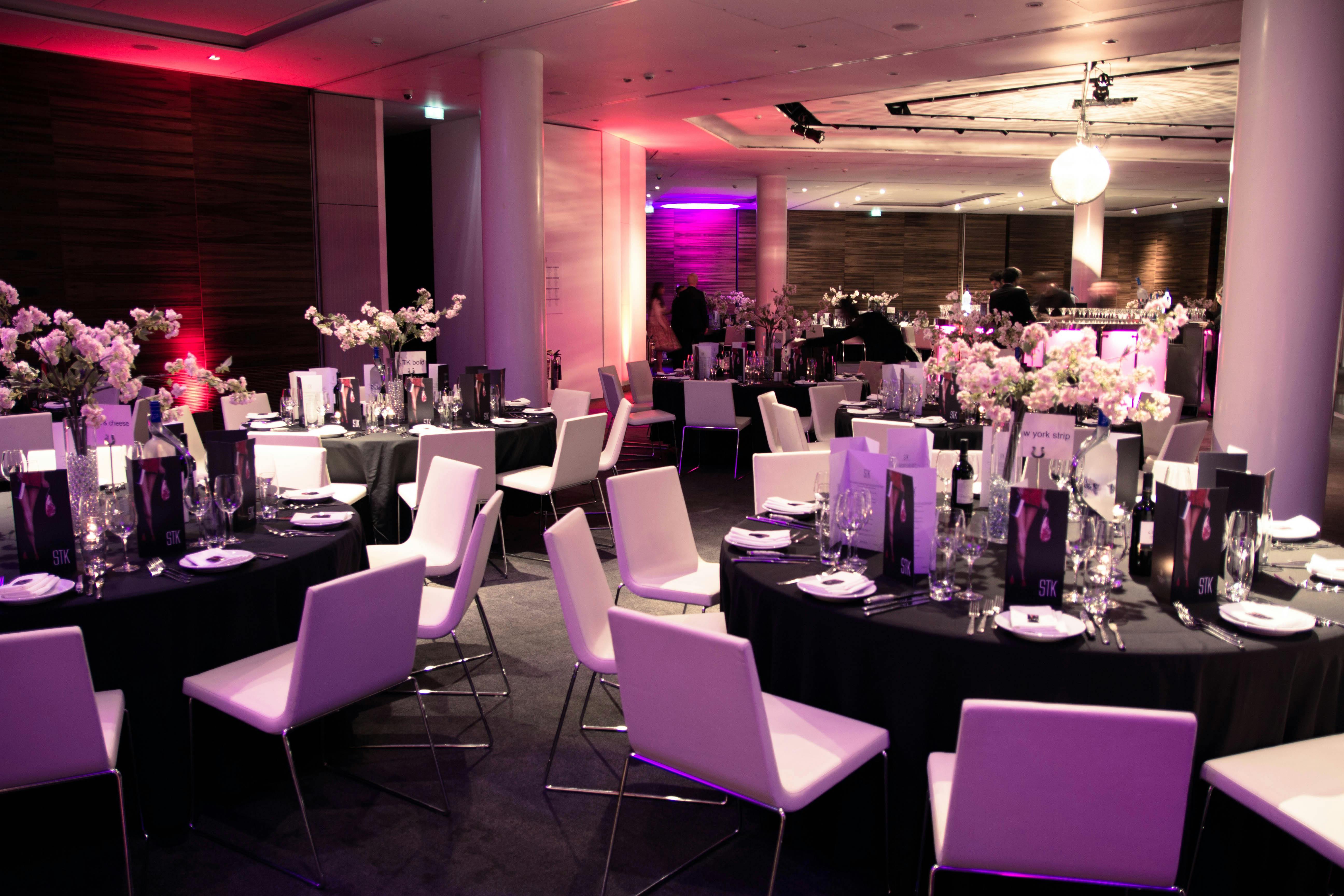 Elegant dinner setup in ME London Event Space with floral centerpieces for corporate events.