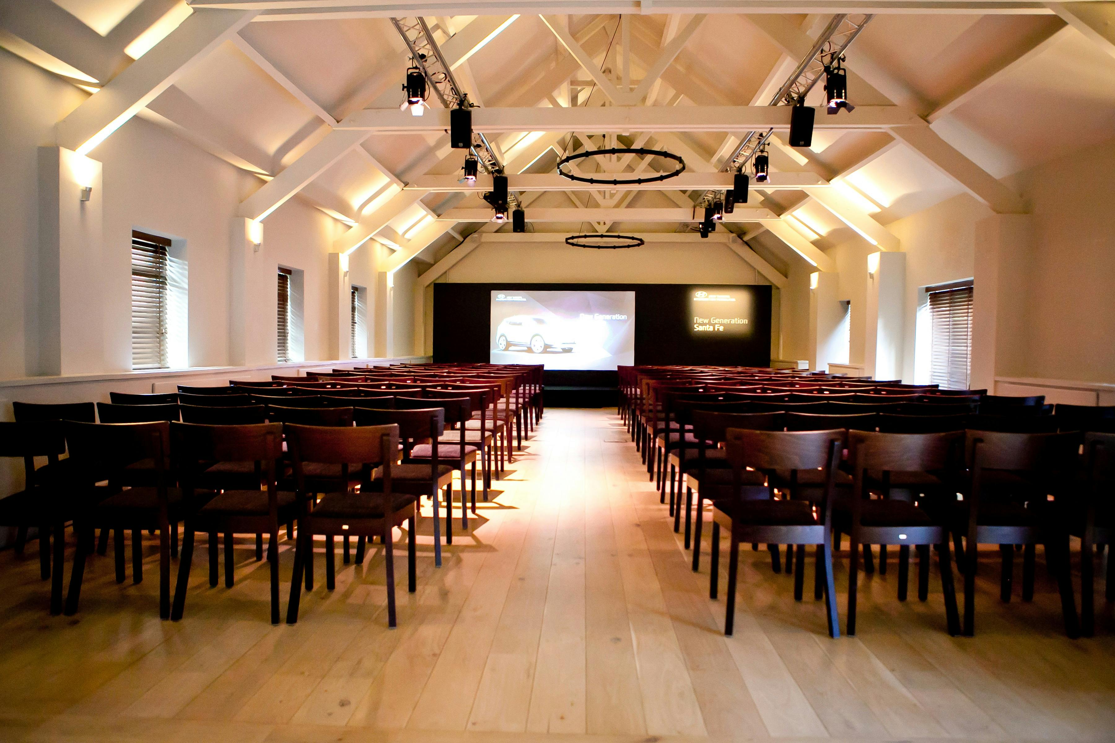 Ballroom at Stoke Place: spacious event space with high ceilings, ideal for presentations.