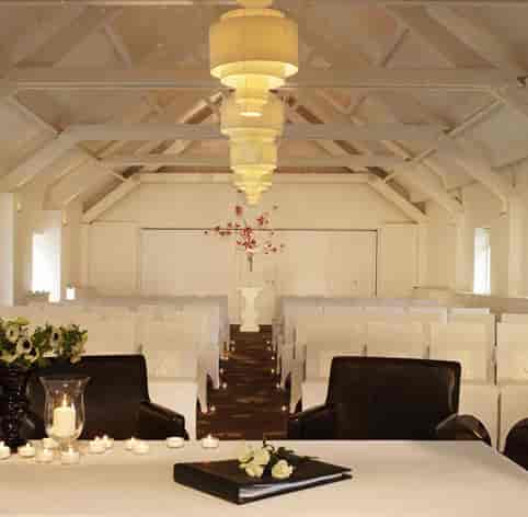 Ballroom at Stoke Place with white chairs, ideal for elegant ceremonies and events.