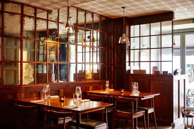 Stylish restaurant interior with warm wood accents, ideal for private events and gatherings.