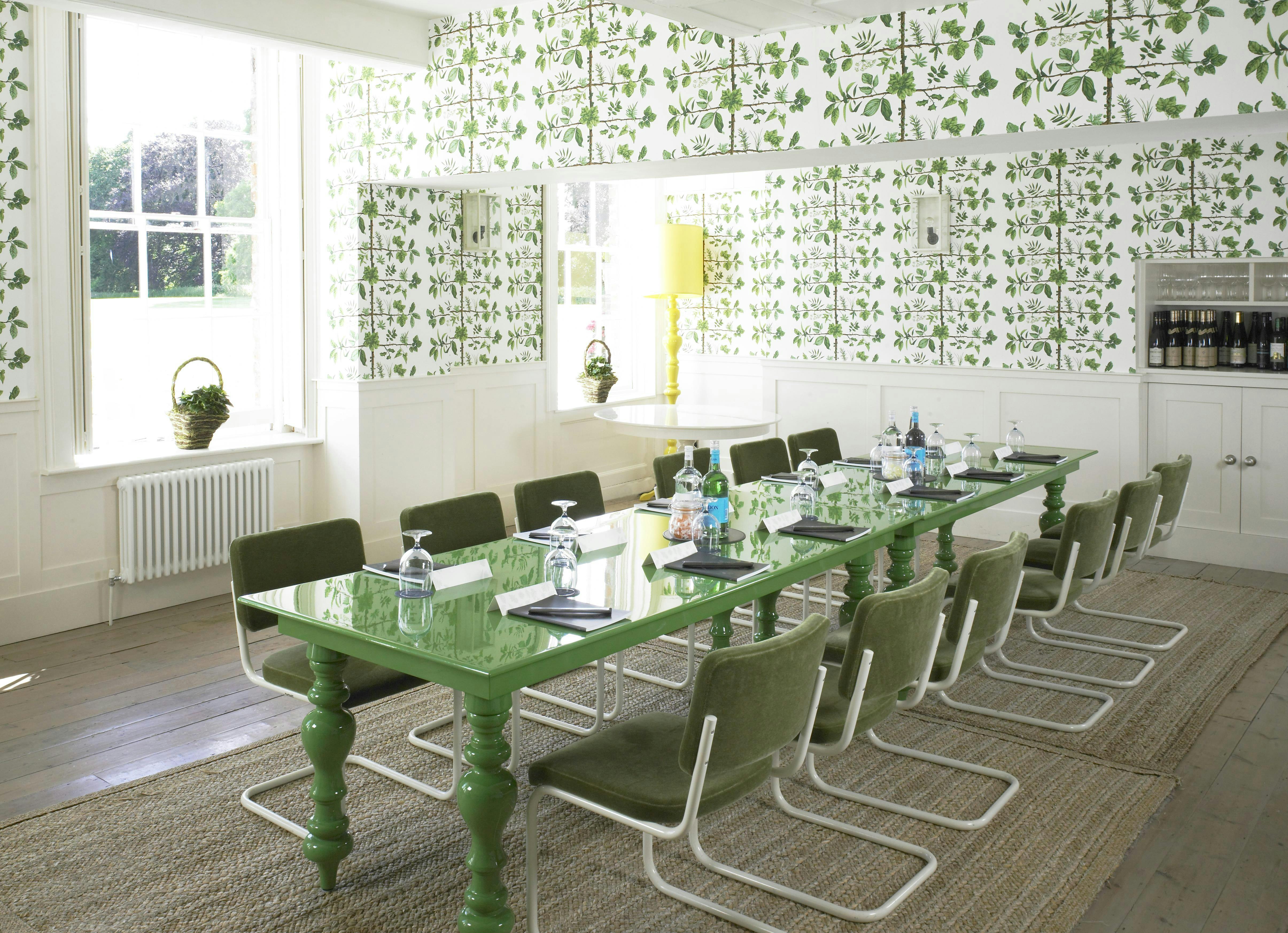 Stylish meeting room with green glass table, ideal for creative brainstorming sessions.