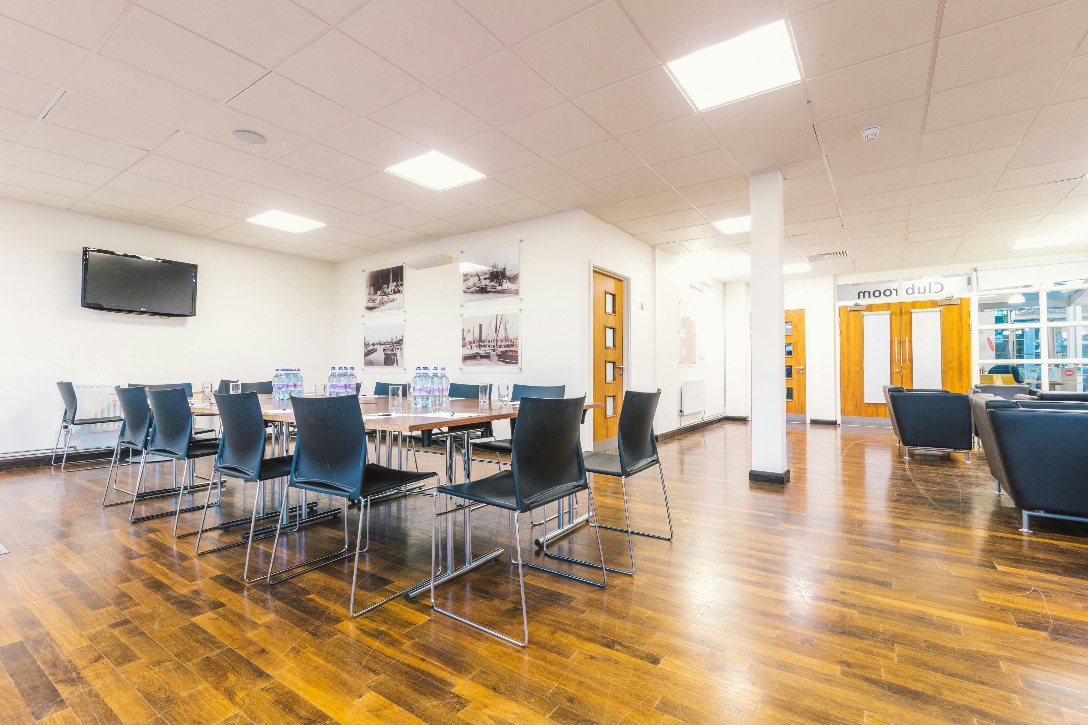 Surrey Docks club room with central table, ideal for corporate meetings and events.