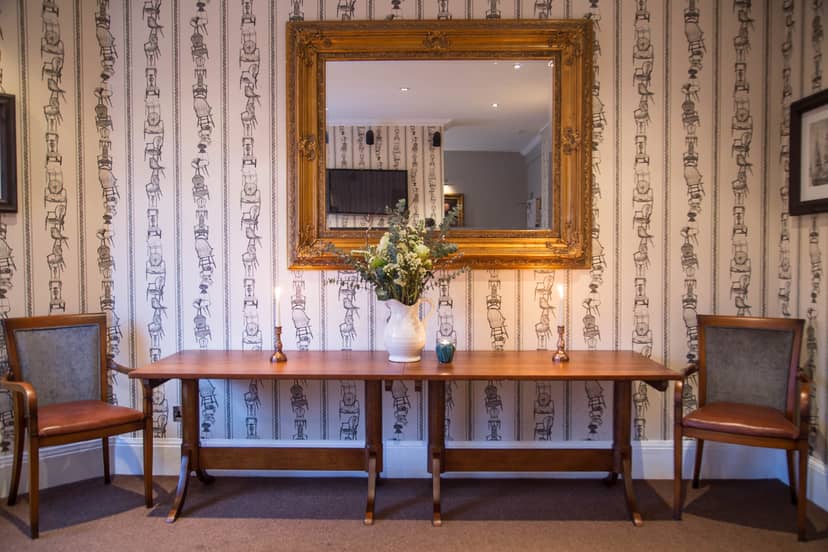 Elegant entryway of The Navarino Room for events with stylish seating and decor.