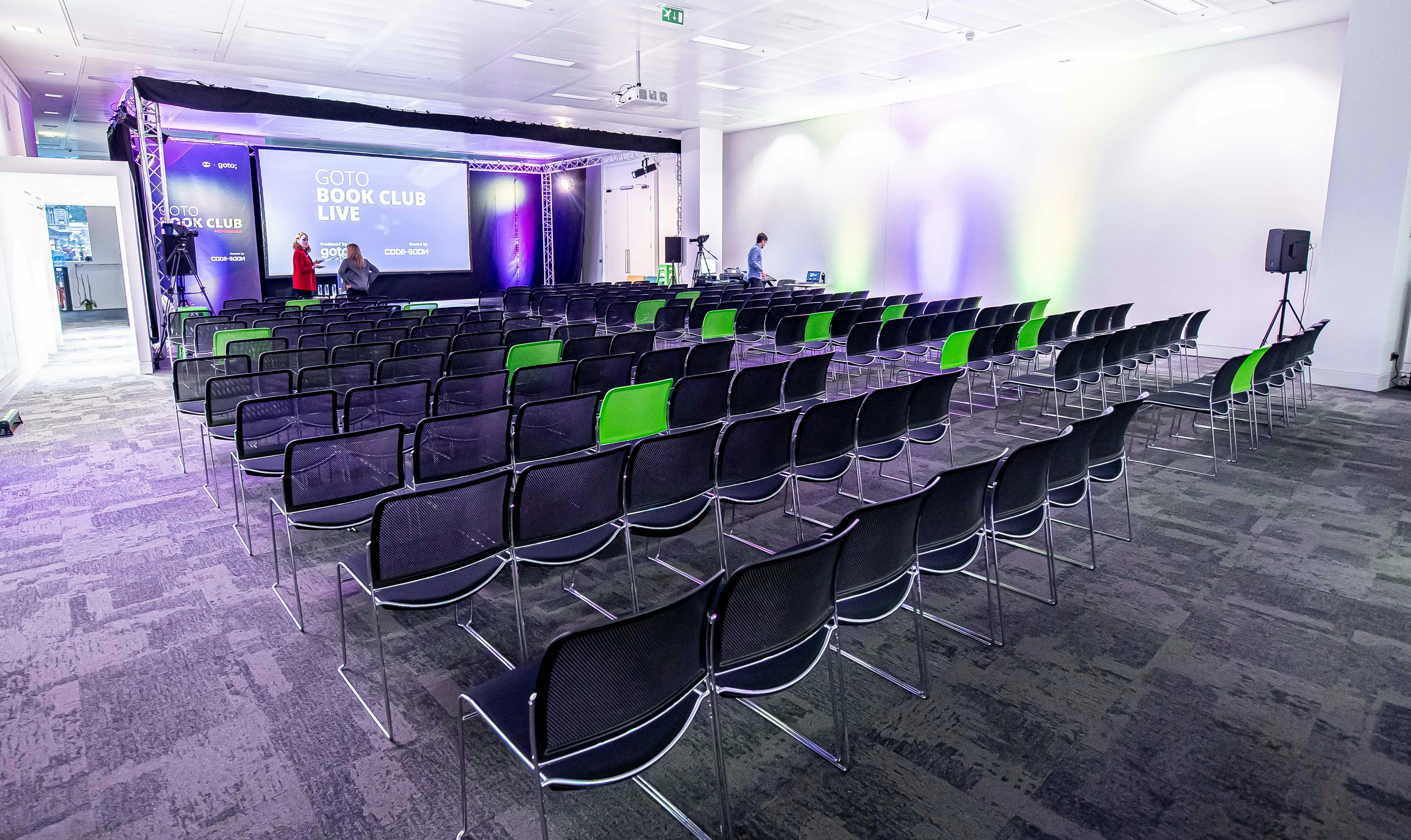 Book club live session at CodeNode with organized seating and inviting lighting.