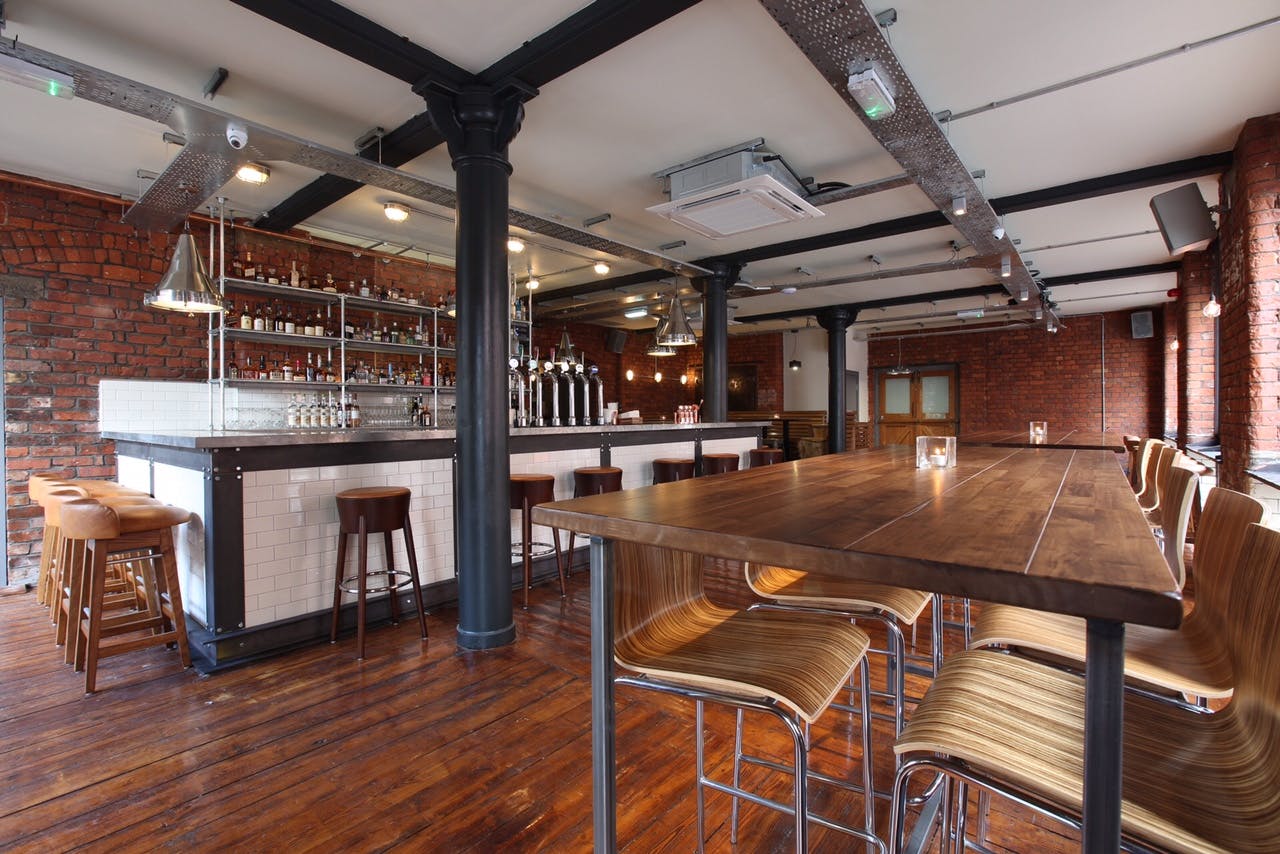 Stylish modern venue with exposed brick, ideal for intimate meetings and cocktail receptions.