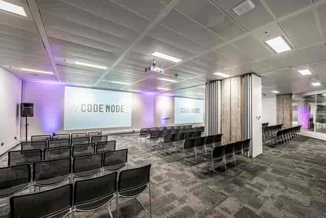 Modern London venue: dual screens, event space, conference, product launch.