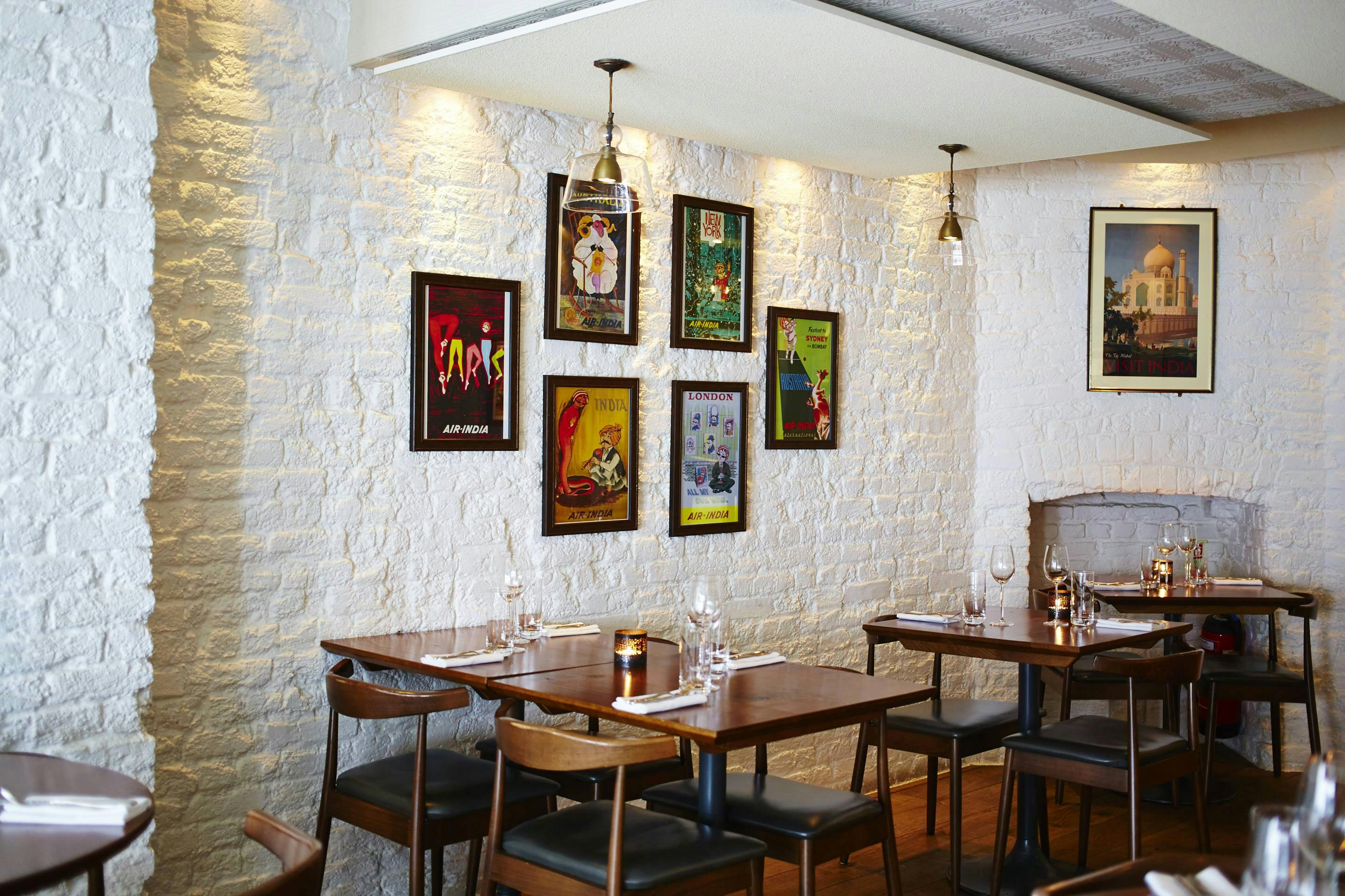 Stylish restaurant interior with white brick wall, perfect for intimate gatherings and events.