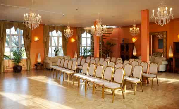 Theater-style event space at The Baroque London with warm chandeliers for intimate ceremonies.
