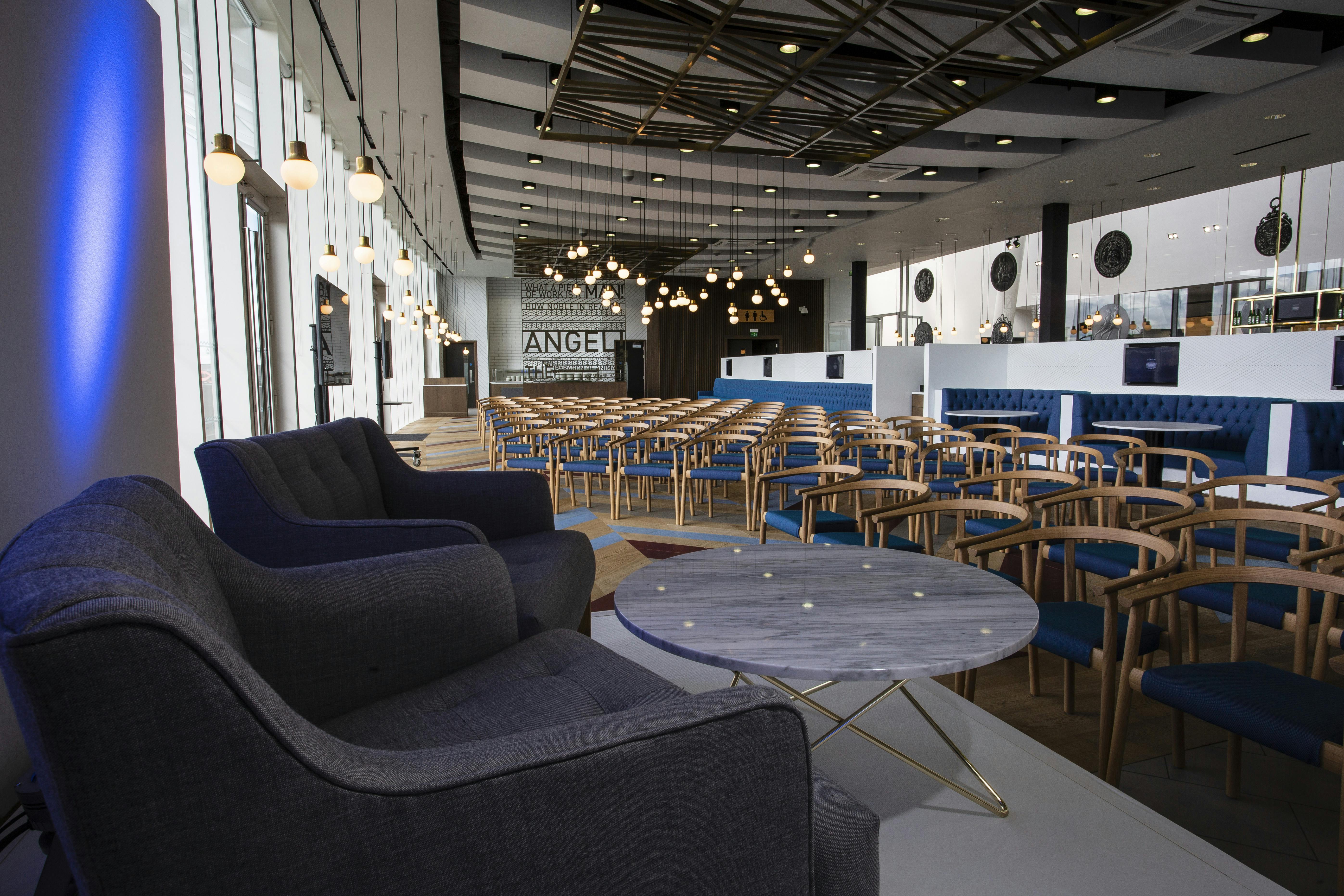 Modern event space in London Stadium with plush seating for meetings and networking.