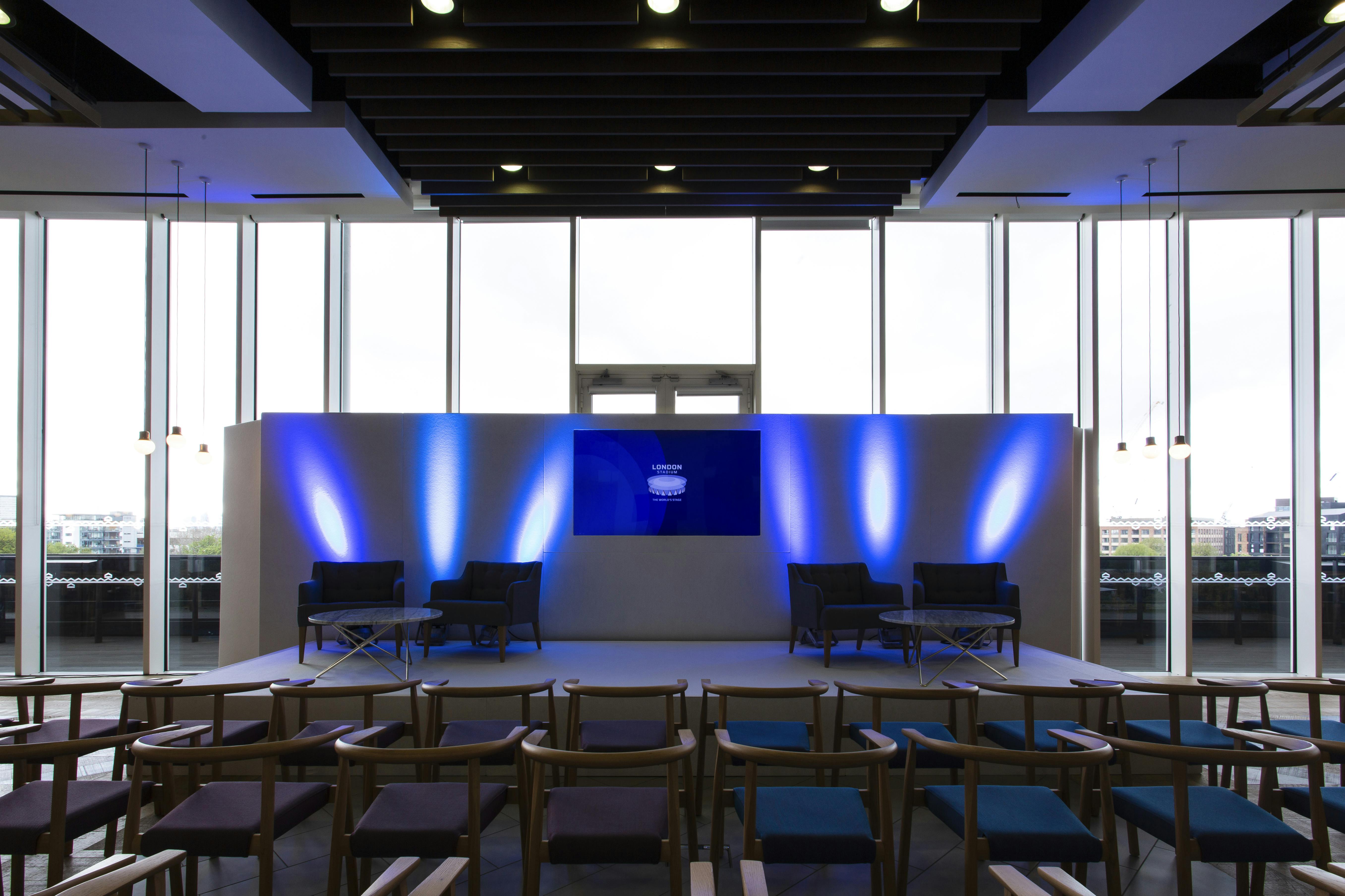 Event space at London Stadium with sleek stage, ideal for conferences and panel discussions.