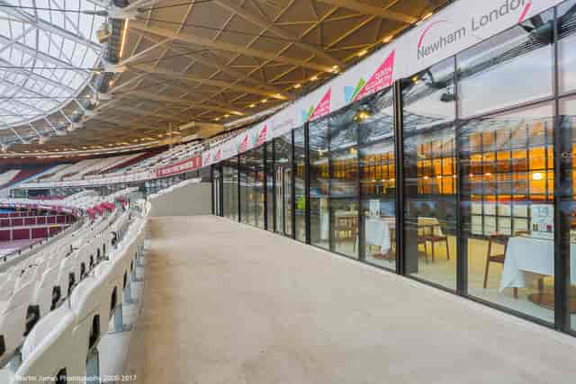 Modern event space in London Stadium with sleek glass walls for corporate meetings.