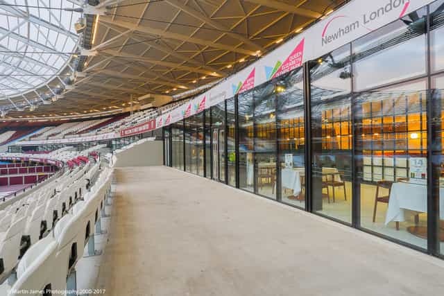 Modern event space in London Stadium with sleek glass walls for corporate meetings.