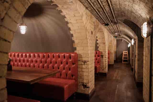 Stylish underground venue with brick arches, ideal for intimate gatherings and events.