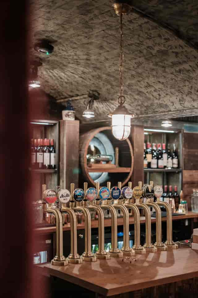 Lower Deck bar with beer taps, warm lighting for networking events and social gatherings.
