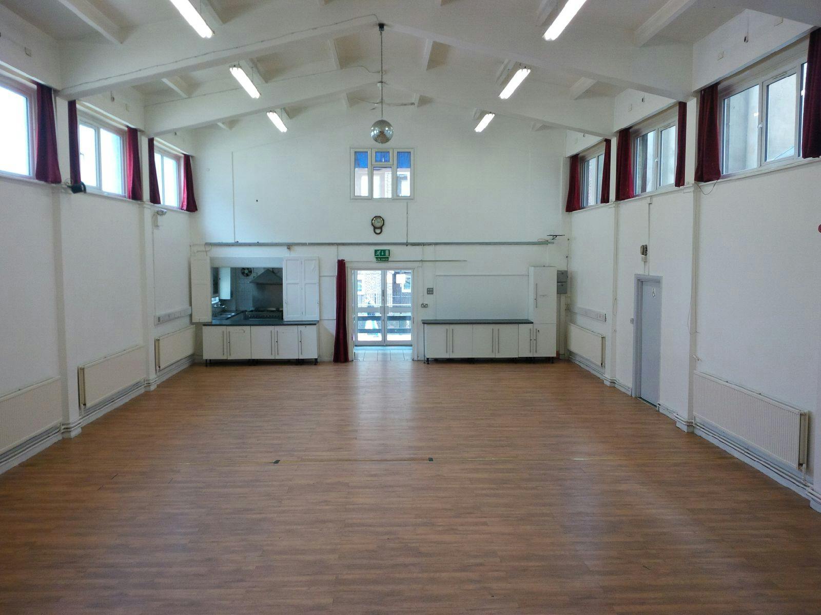 Spacious Main Hall at Centre 151 with wooden flooring, perfect for meetings and events.