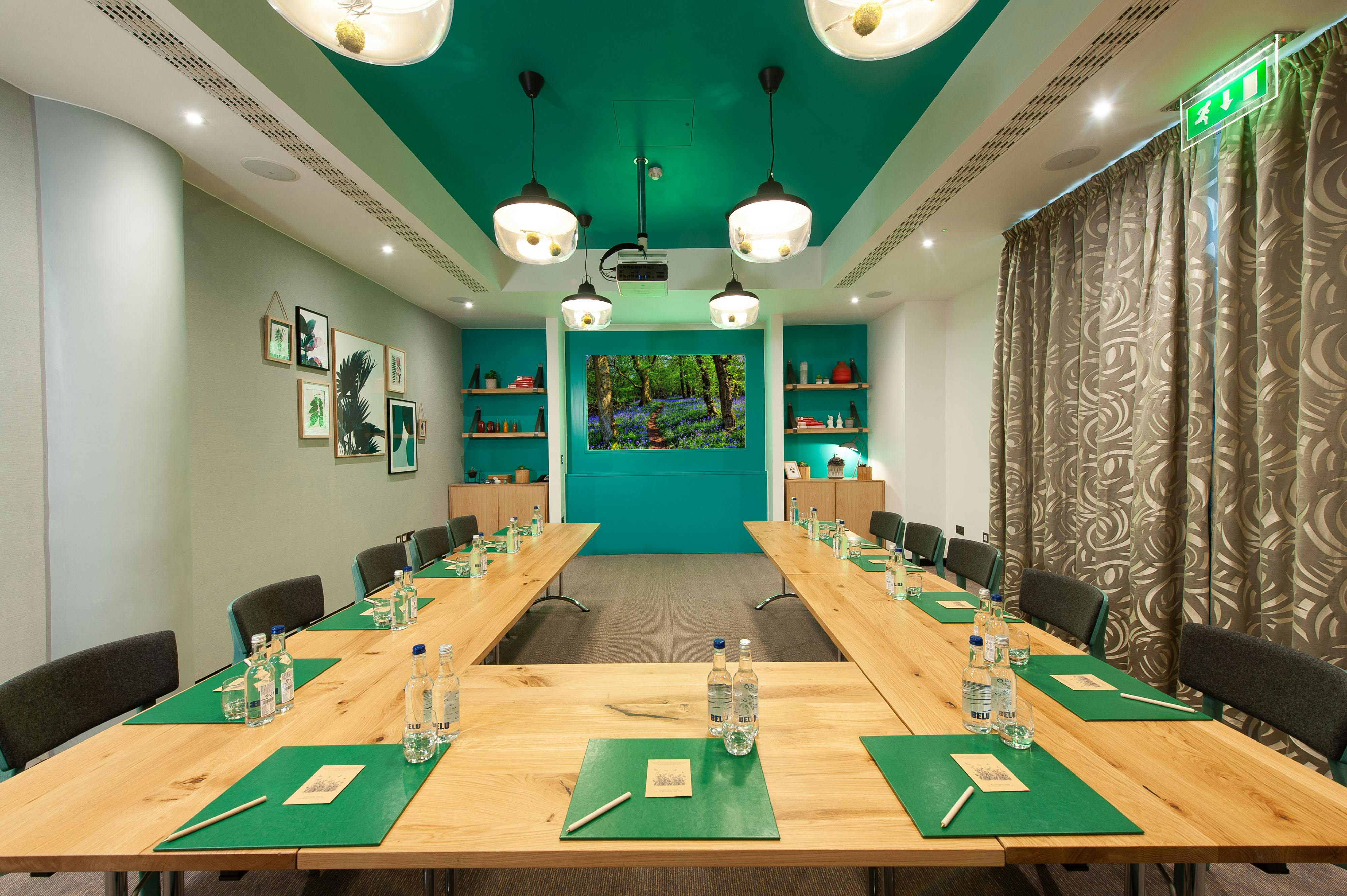 Garden Room at Crowne Plaza London Kensington, teal walls, ideal for workshops and meetings.