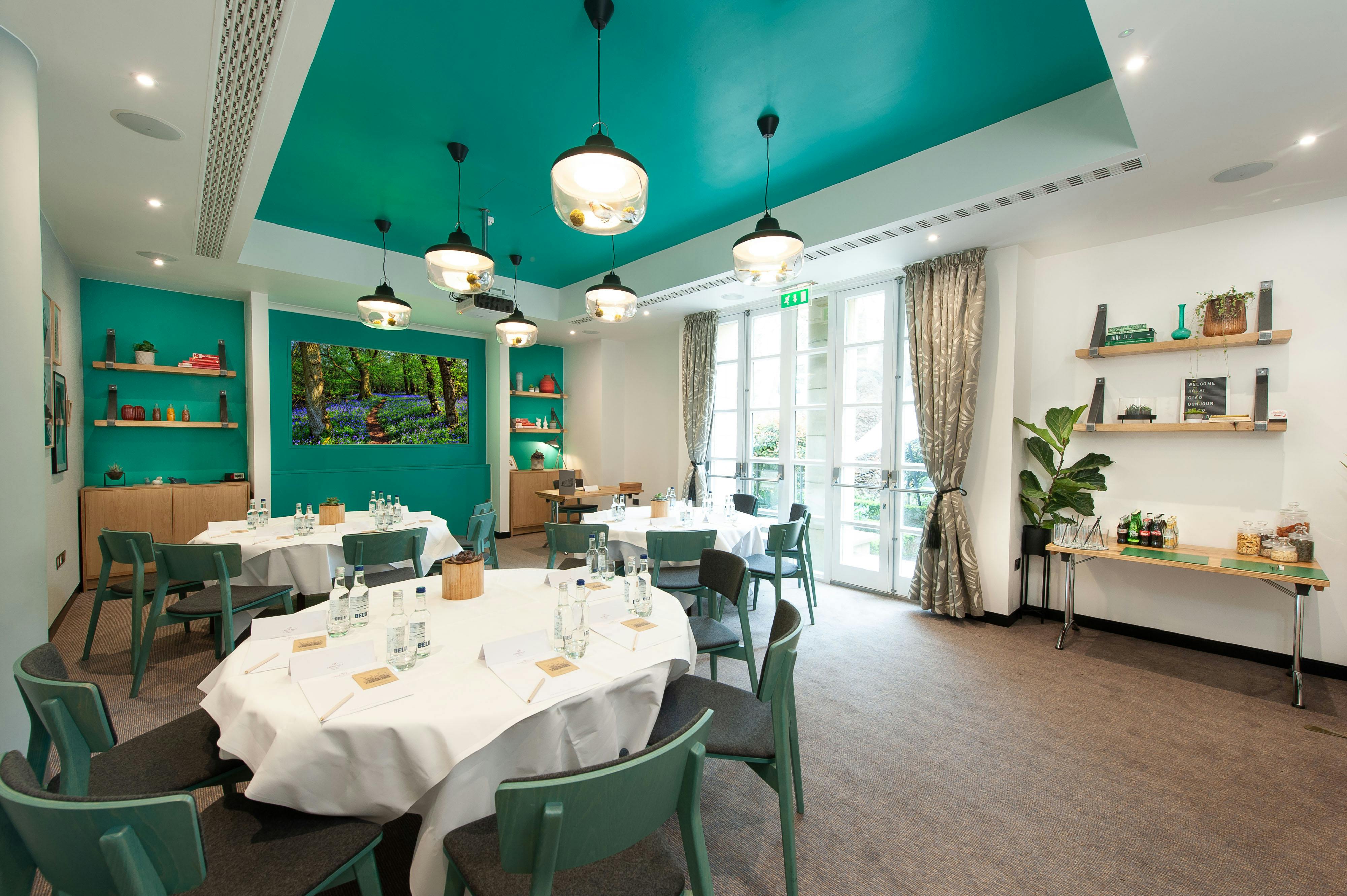 Garden Room at Crowne Plaza London Kensington, elegant meeting space with teal decor.