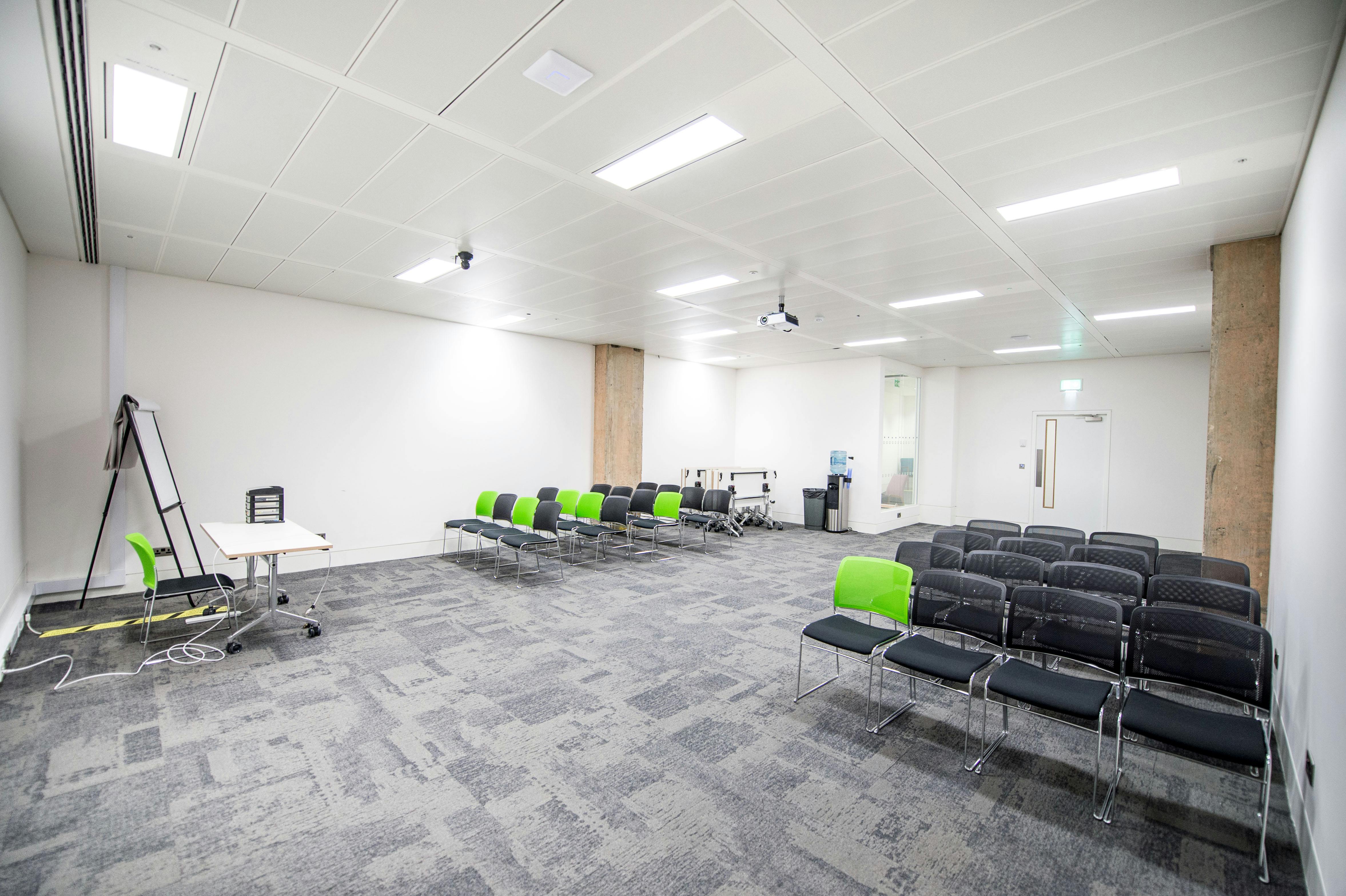 Versatile meeting space at CodeNode with modern seating for workshops and presentations.