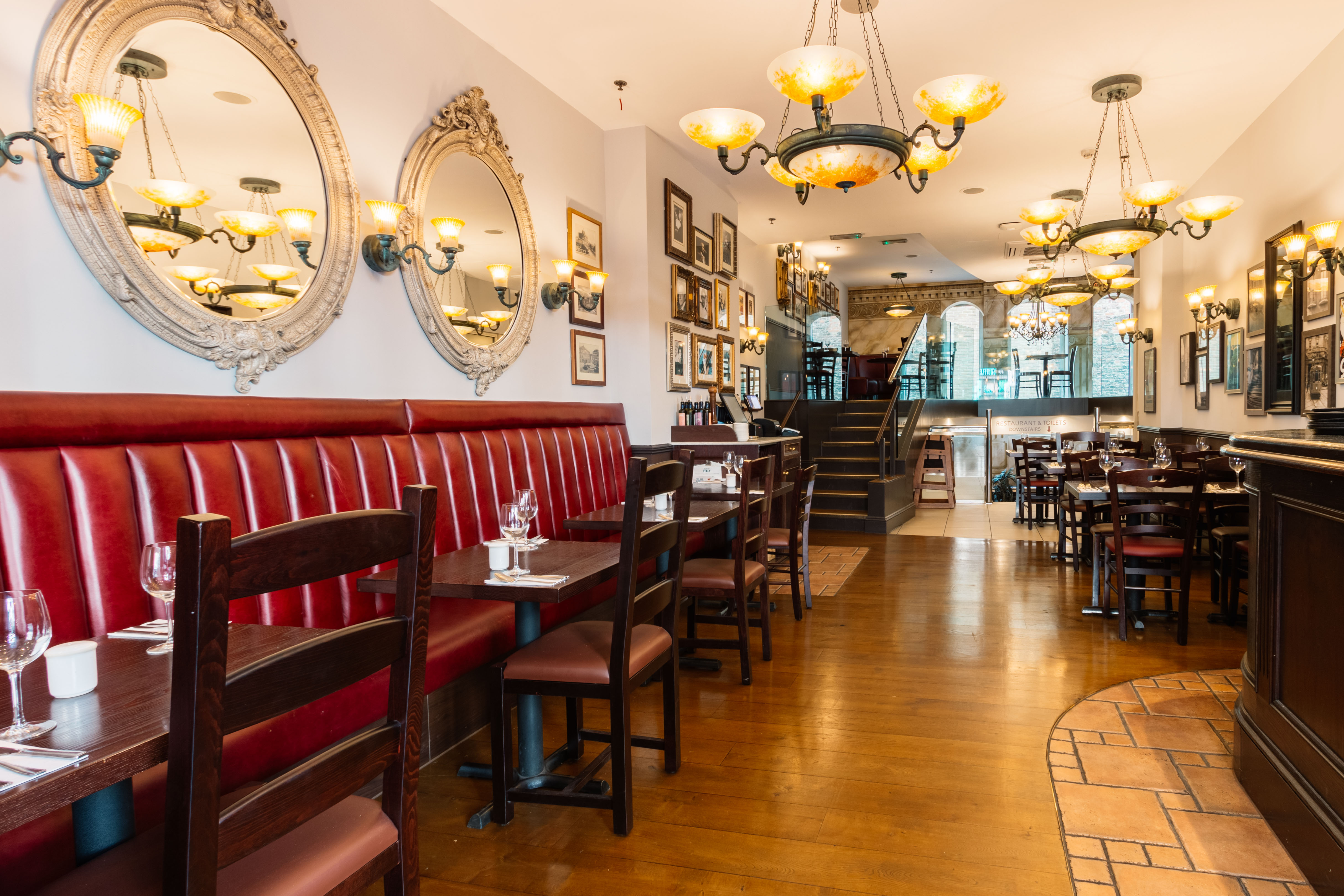 Stylish Bella Italia Strand venue with warm lighting for intimate gatherings and events. - Banner