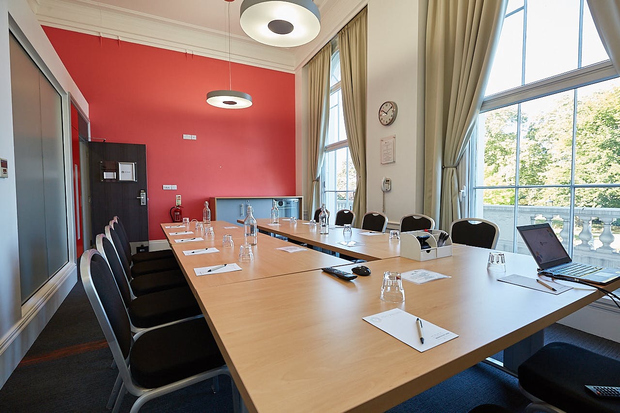 Meeting room at The Marylebone, featuring a long wooden table for professional gatherings.