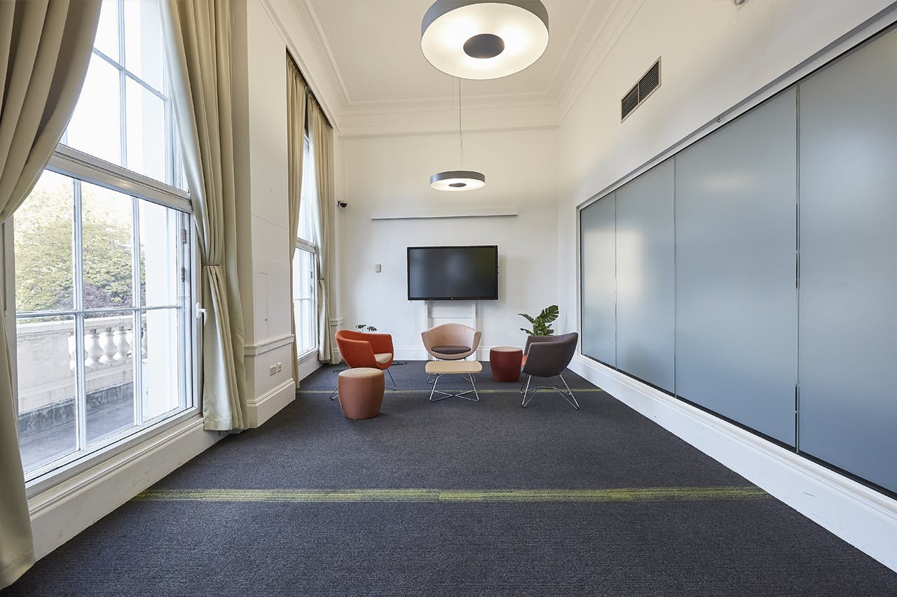 Modern meeting space at The Fitzrovia, featuring natural light and tech for collaboration.