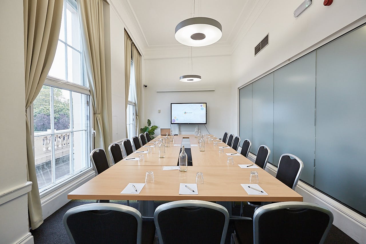 Meeting room at The Fitzrovia, featuring a large table and modern tech for corporate events.