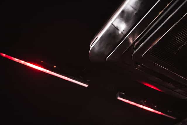 Sleek ceiling fixture with red lighting at The Blackbox, ideal for events and meetings.