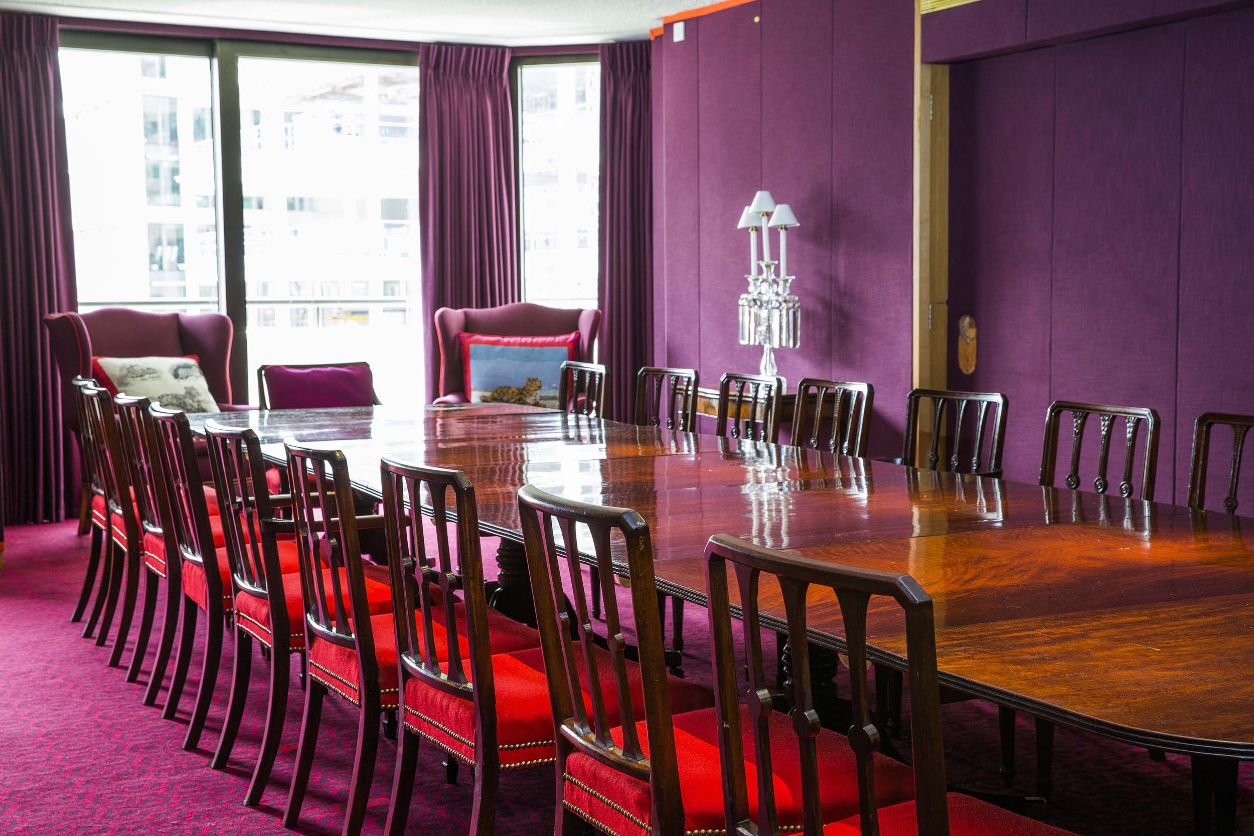 Sophisticated meeting room with purple walls, ideal for executive meetings and workshops.